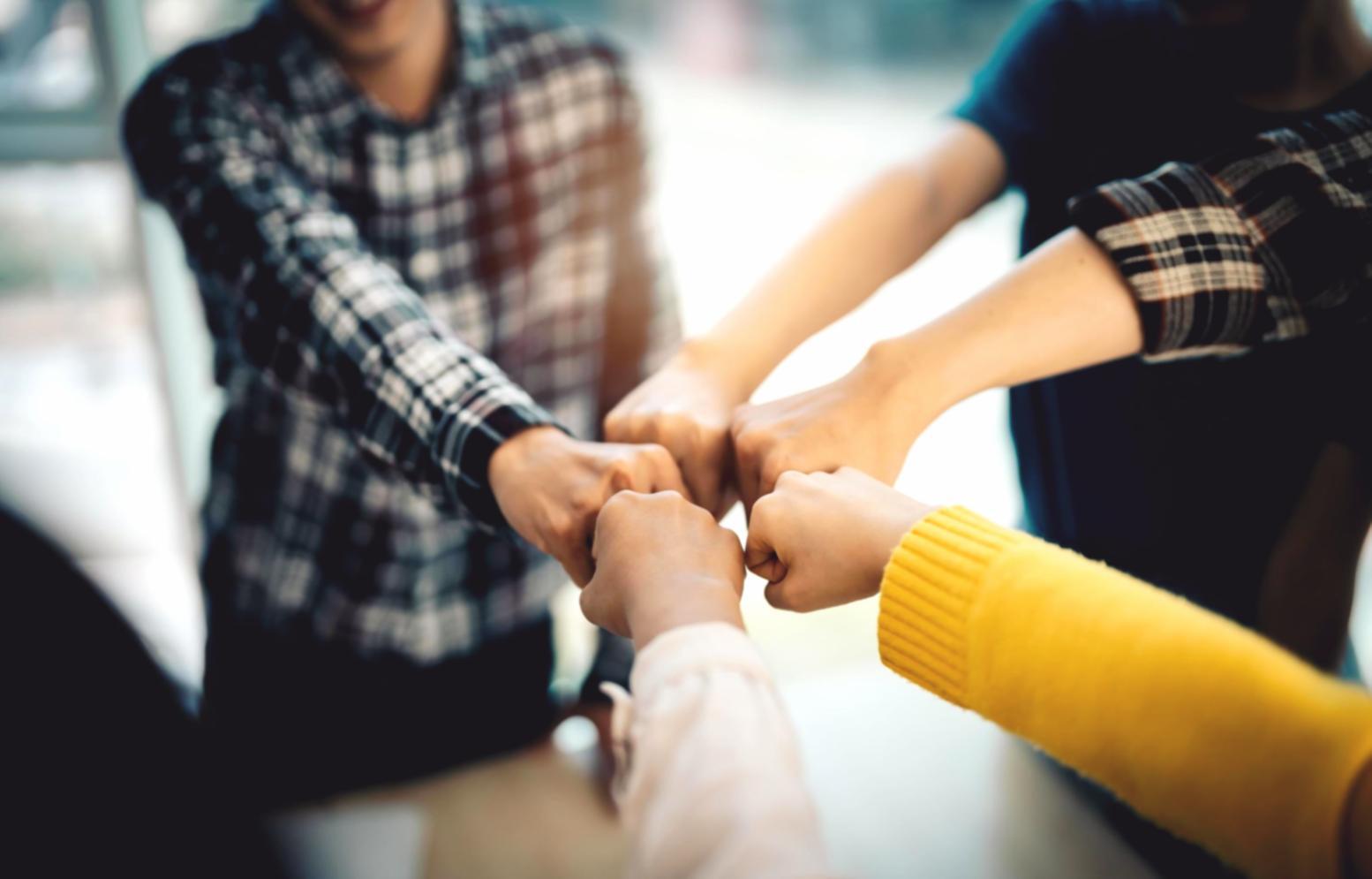 Students analyzing market data and discussing trading strategies in classroom setting